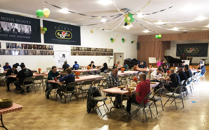 another wide angle of banquet hall with prople seated at tables
