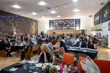 wide angle pic of banquet hall, all chairs full