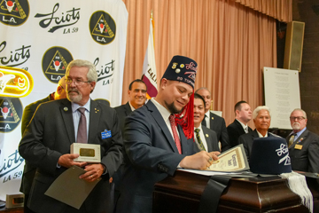 Toparch Ron signs certificates