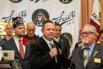 another recipient speaks at microphone