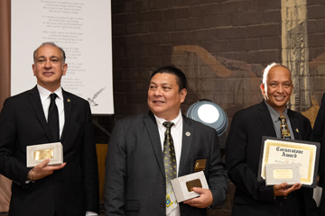 3 recipients of awards showing their awards