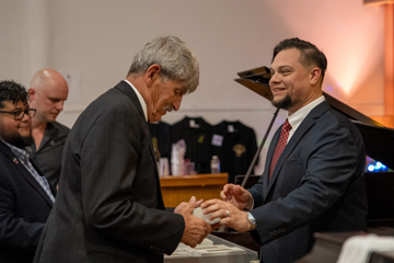 Charles Krefting and Ron Perez transferring award