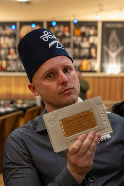 Tim Martin holds up his Cornerstone Award