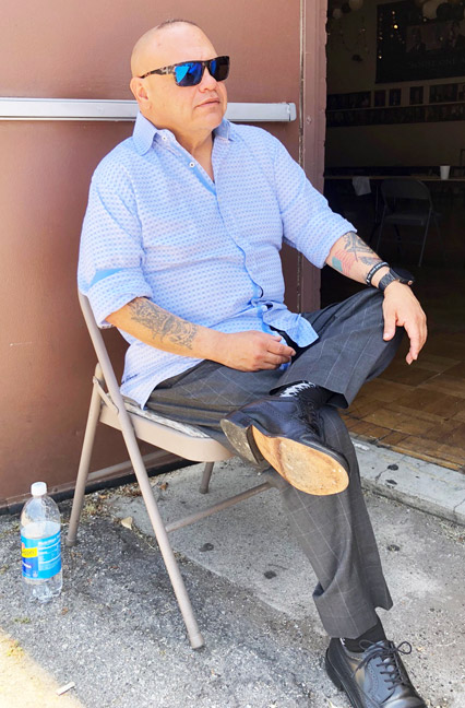 Ralf Lopez, and LA Sciot sitting in chair outside looking cool