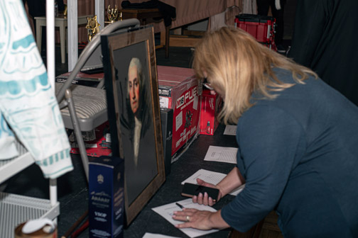 woman signing up for silent auction item